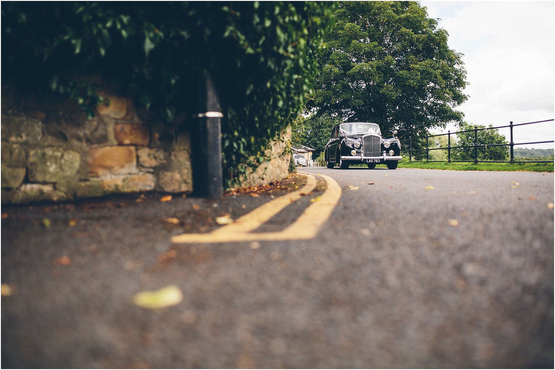 an old black vintage car arrives to take a bride to the Stoneygate Holiday centre in Manchester for a wedding
