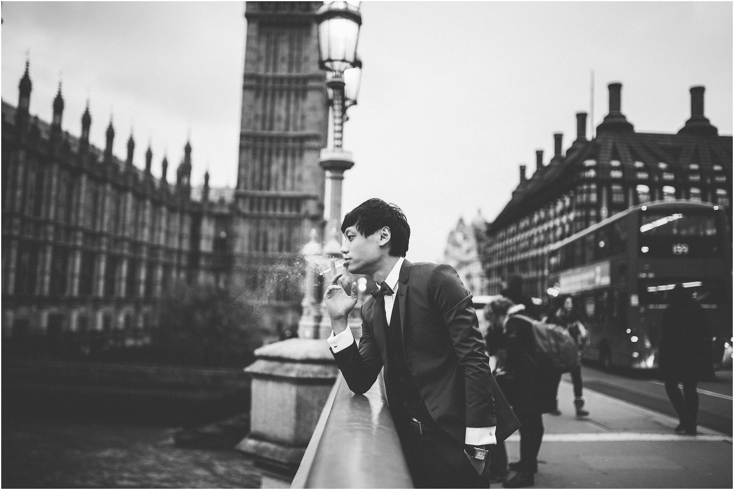 groom smoking in front of big ben and the houses of parliament