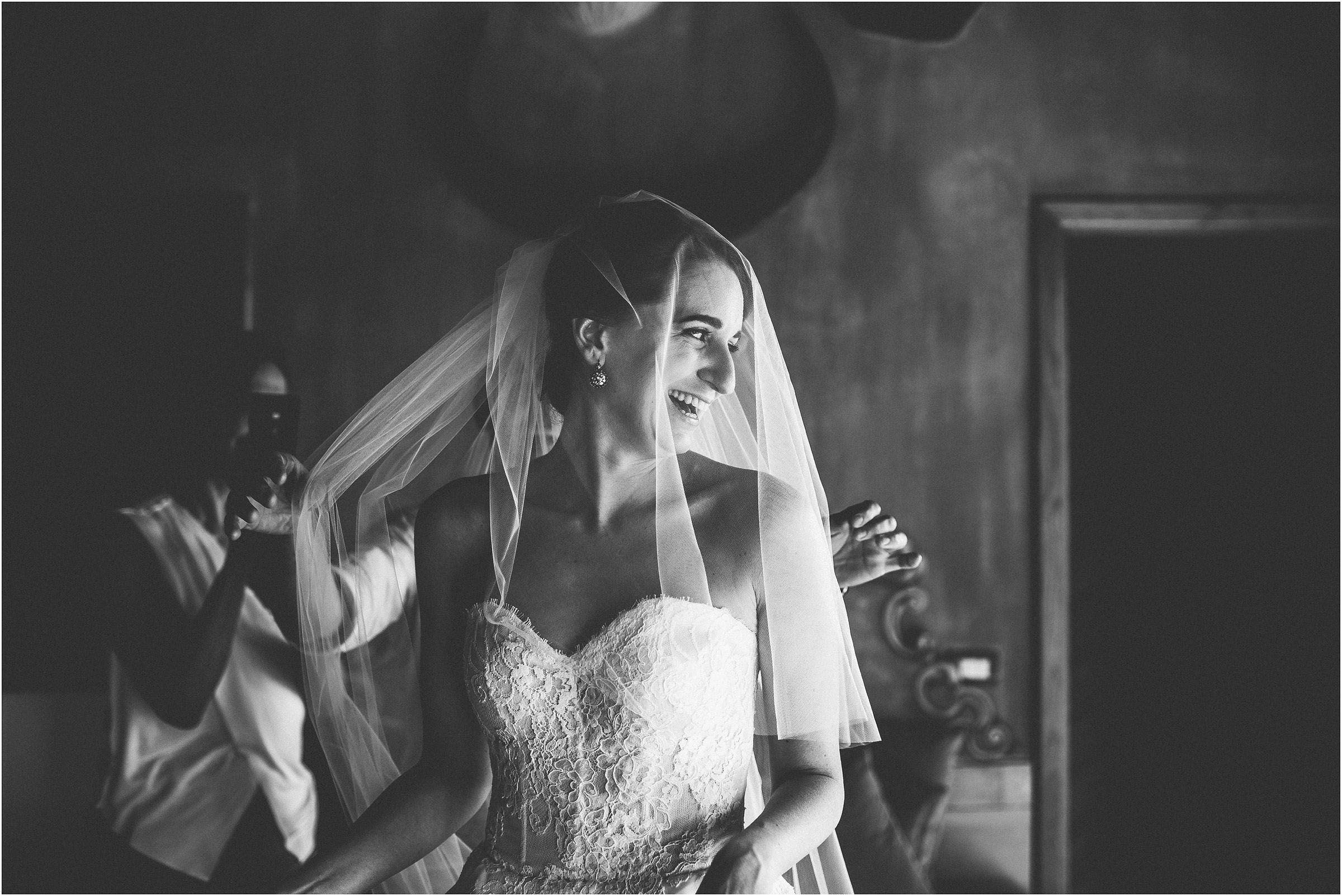 A smiling bride prepares to get married at Castello di Vicarello in Tuscany