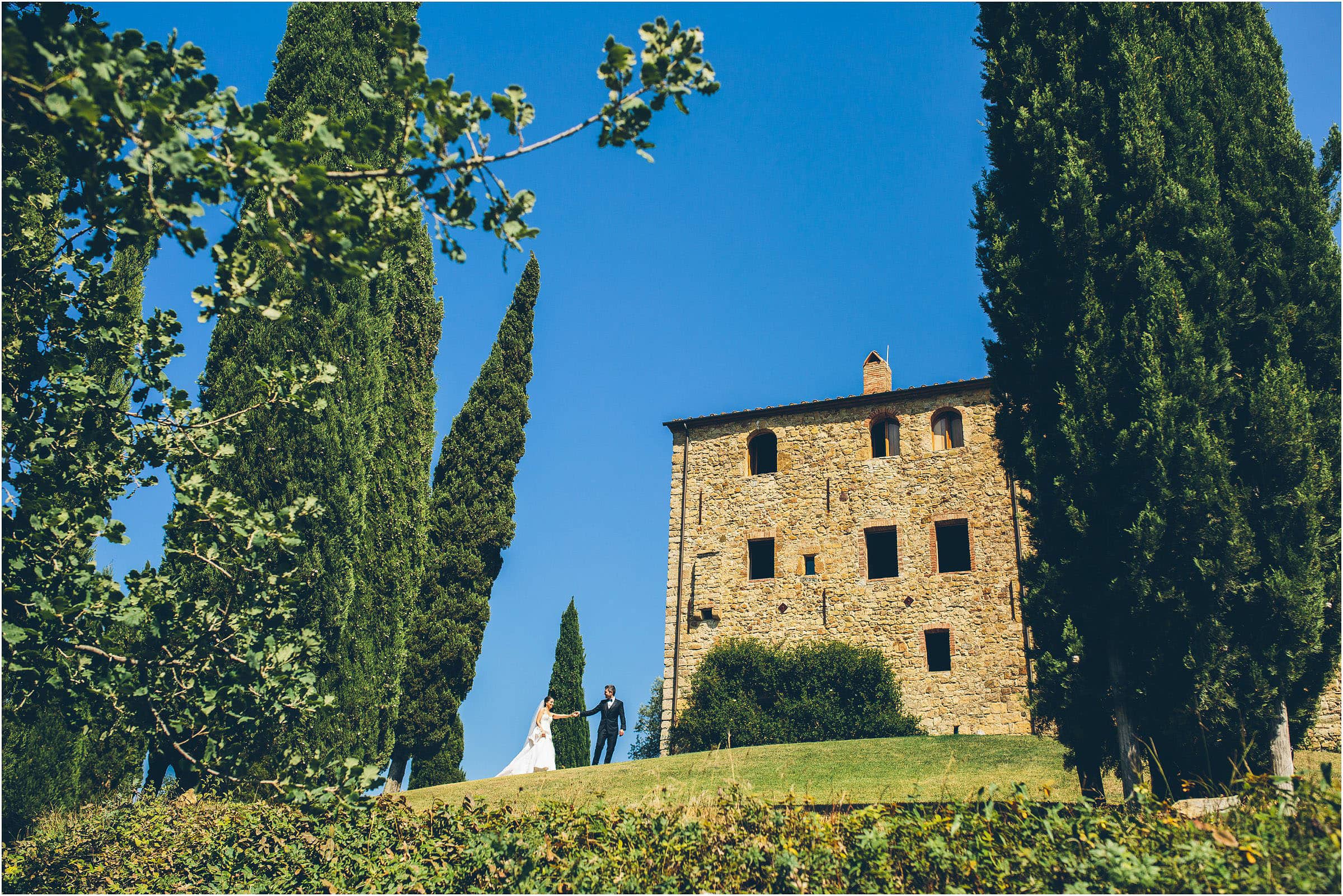 A bride and groom in a classic pose from The Crawleys outside Castello di Vicarello in Tuscany on their wedding day