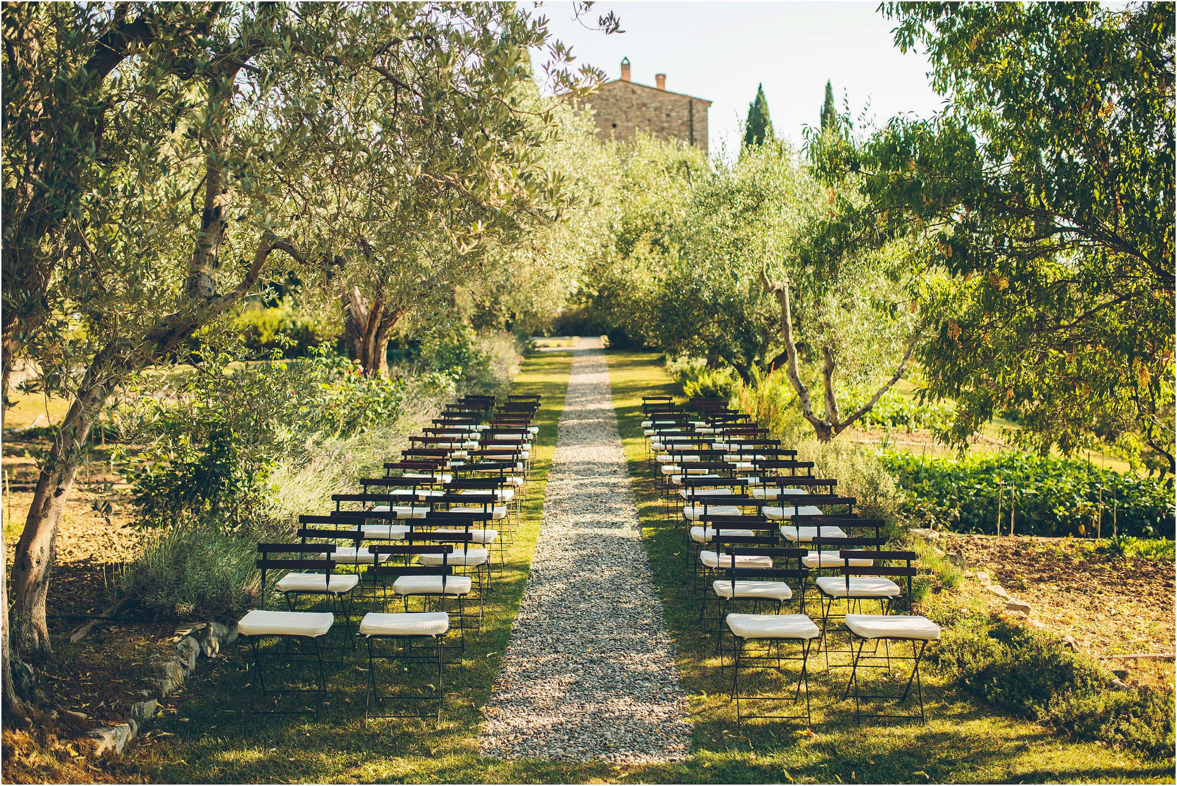 Contemporary and cool the aisle at Castello di Vicarello in Tuscany with empty seat waiting for guests to arrive
