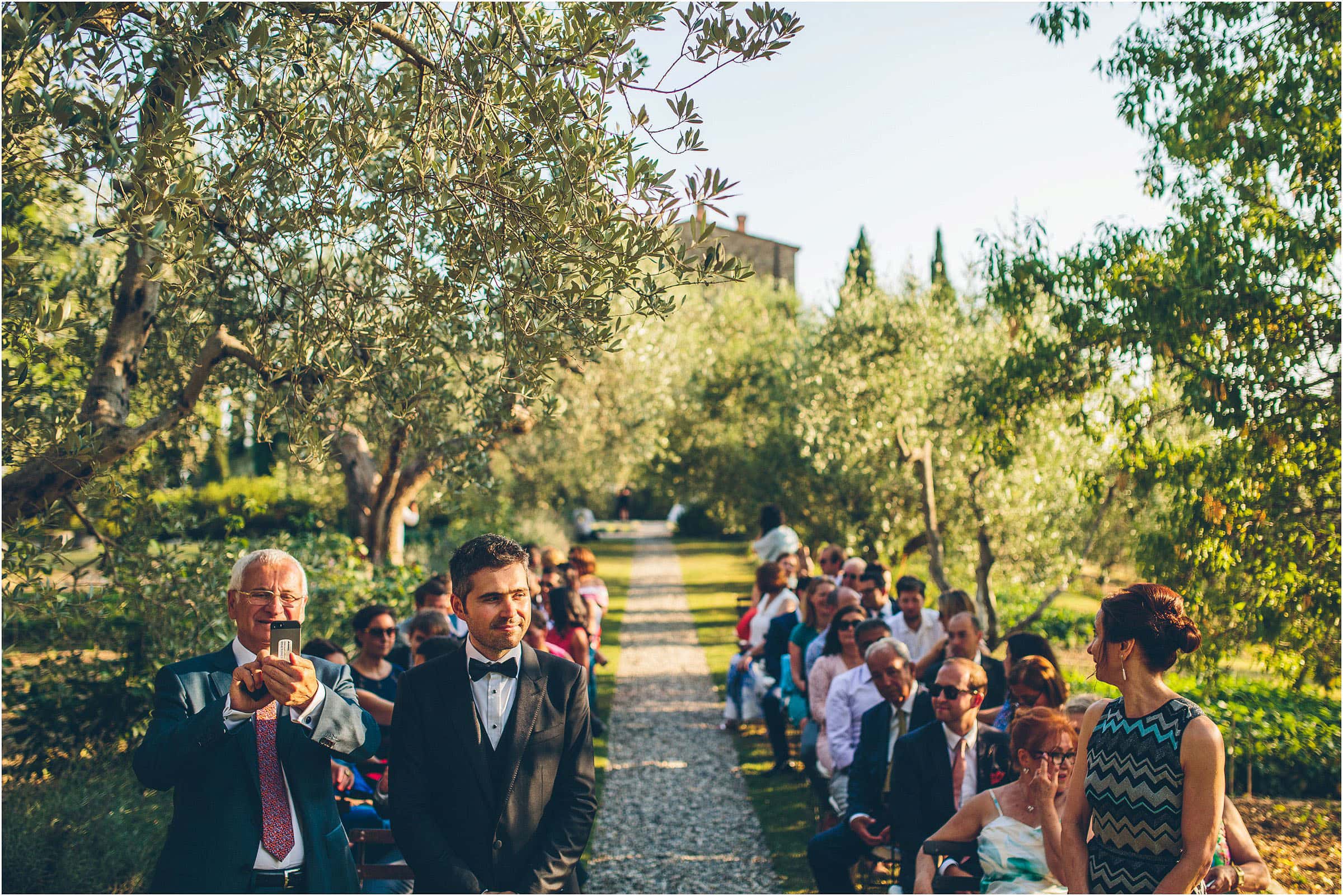 At Castello di Vicarello the groom waits for his bride to walk down the aisle